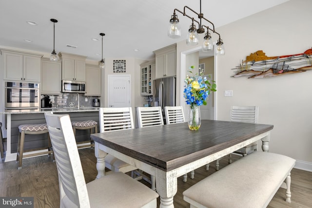 dining space featuring baseboards, recessed lighting, wood finished floors, and visible vents