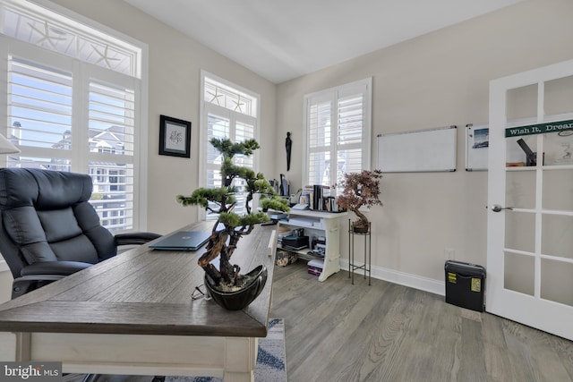 home office with baseboards, wood finished floors, and french doors