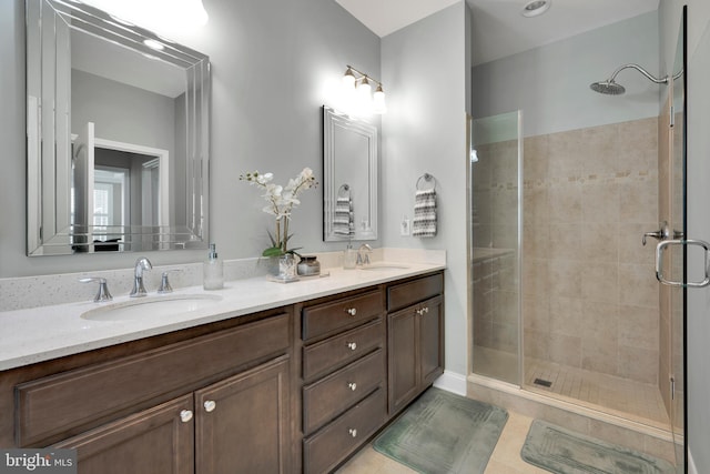 full bathroom with a shower stall, a sink, and tile patterned flooring