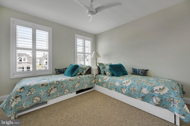 carpeted bedroom with baseboards and ceiling fan