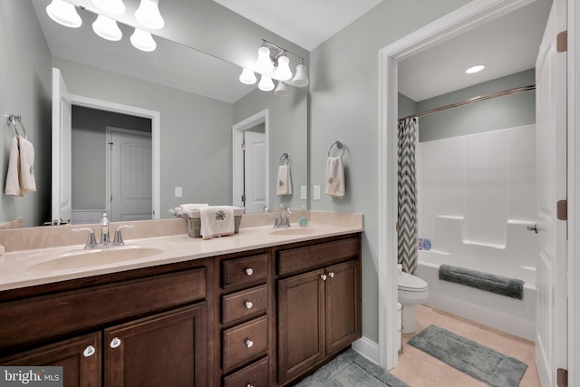 bathroom with double vanity, toilet, a sink, and shower / bath combo with shower curtain
