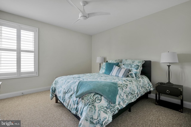 carpeted bedroom featuring baseboards, multiple windows, and ceiling fan