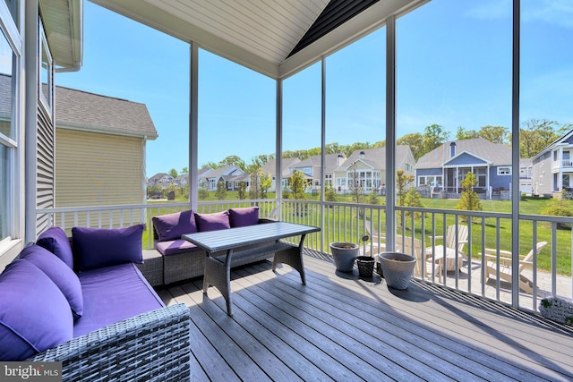 sunroom / solarium featuring a residential view, an outdoor hangout area, and a wealth of natural light