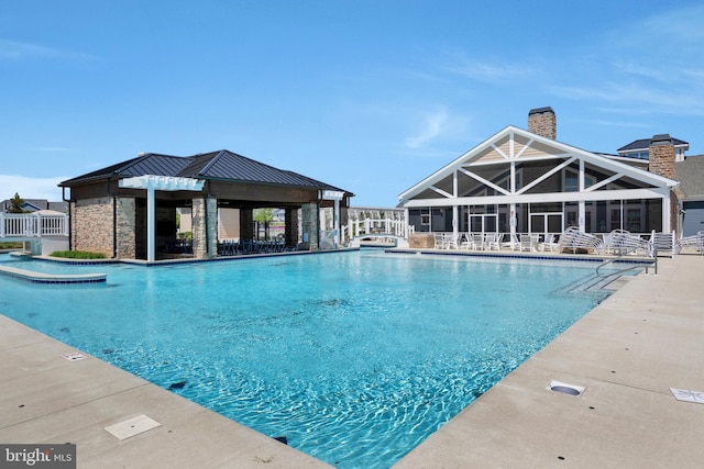 pool with a patio and fence
