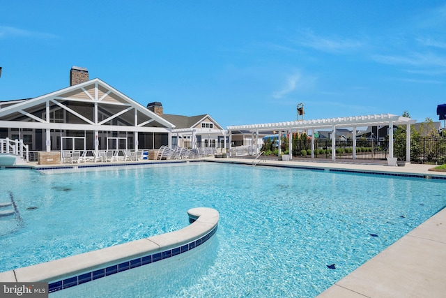 pool with fence and a pergola