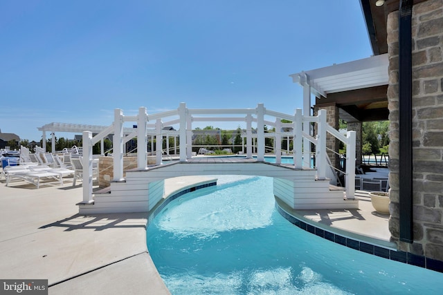 community pool featuring a pergola