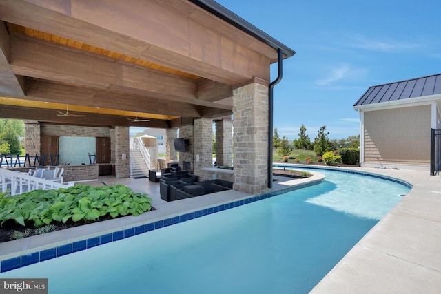 pool with a patio, an outdoor living space, and exterior bar