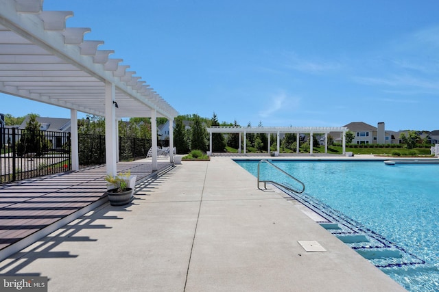 community pool with fence, a pergola, and a patio area