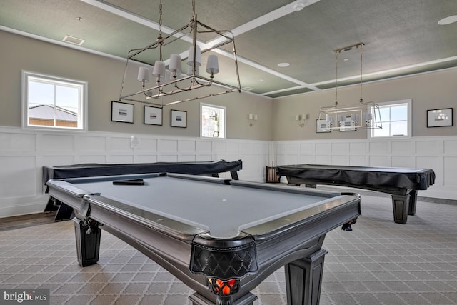 recreation room with billiards, a wainscoted wall, and a notable chandelier