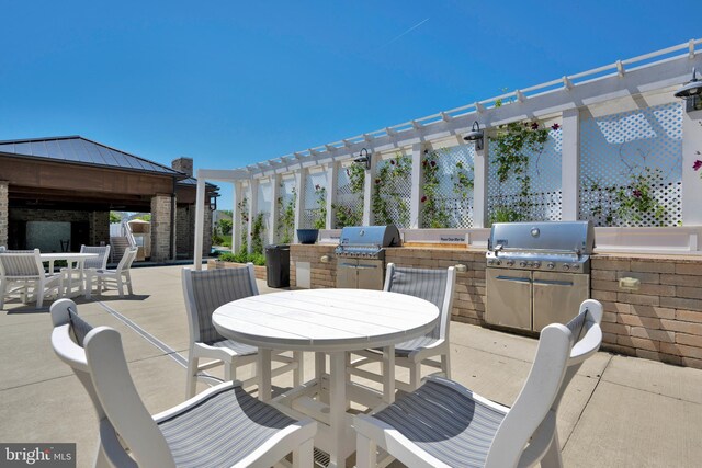 view of patio with area for grilling, a pergola, grilling area, and outdoor dining space