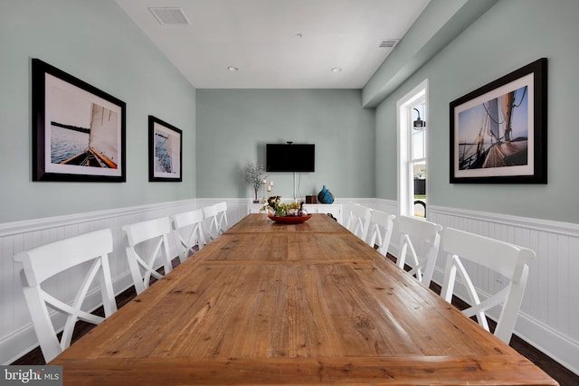 dining space with wainscoting and visible vents