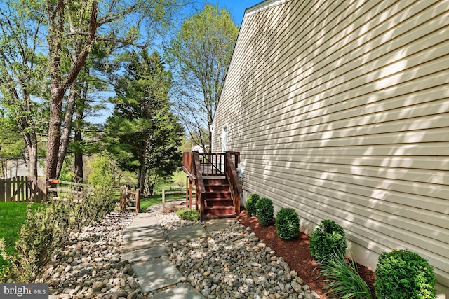 view of side of property featuring fence