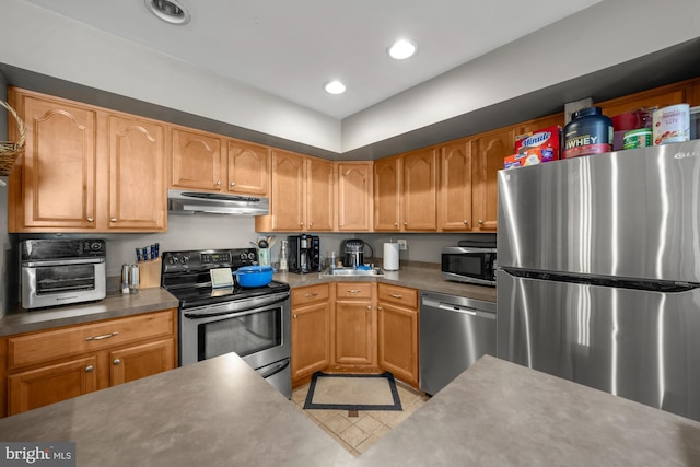 kitchen with under cabinet range hood, a toaster, recessed lighting, and appliances with stainless steel finishes