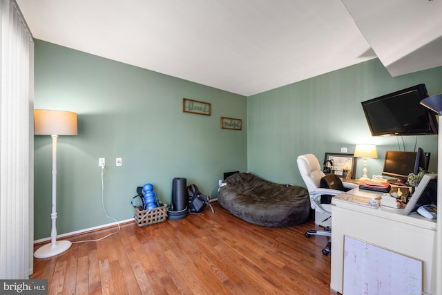 home office featuring wood finished floors and baseboards