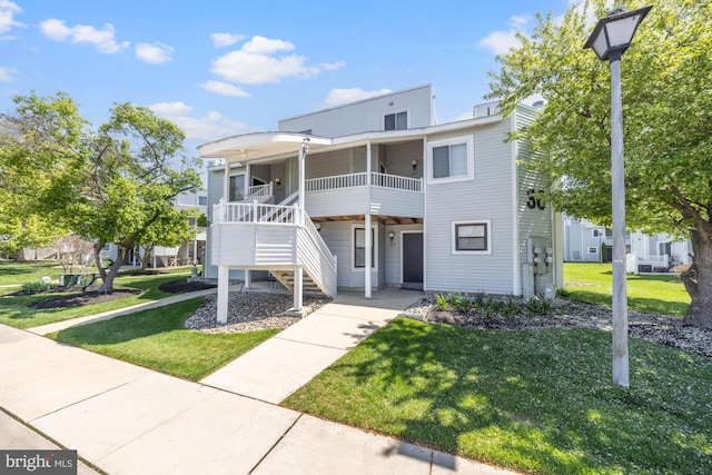 exterior space featuring a front lawn and stairway