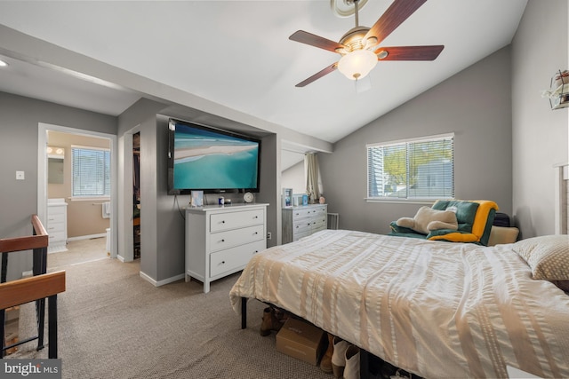 bedroom with baseboards, light colored carpet, lofted ceiling, a ceiling fan, and connected bathroom