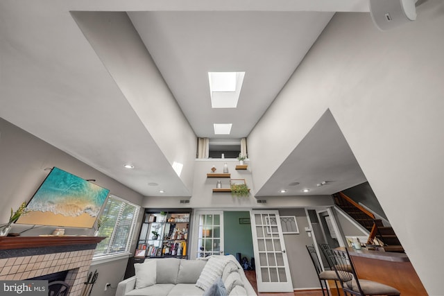 living area with french doors, visible vents, and a fireplace