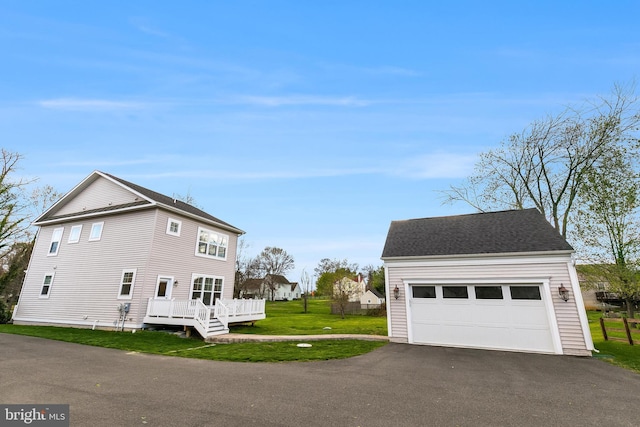 625 E G St, Purcellville, VA 20132 - view of home's exterior featuring a detached garage, a lawn, a shingled roof, an outdoor structure, and a wooden deck