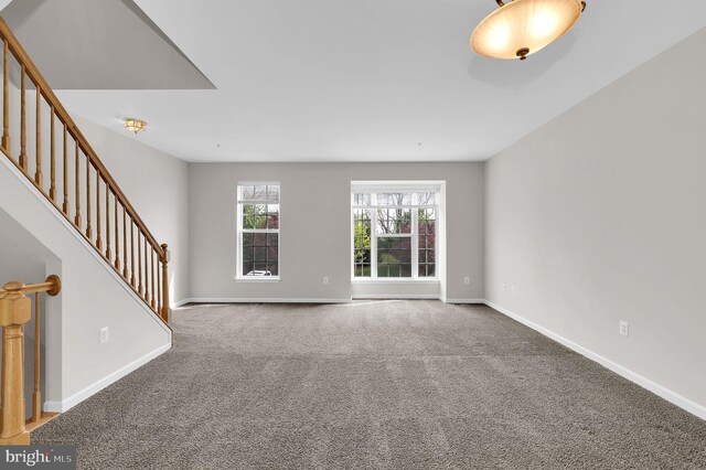 2475 Lakeside Dr, Frederick, MD 21702 - unfurnished living room with stairway, carpet floors, and baseboards