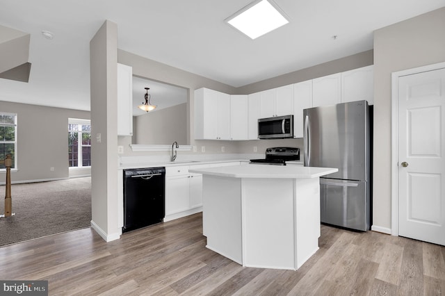 2475 Lakeside Dr, Frederick, MD 21702 - kitchen with a center island, a sink, stainless steel appliances, light countertops, and white cabinetry