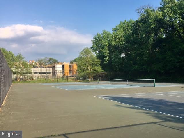 view of tennis court featuring fence
