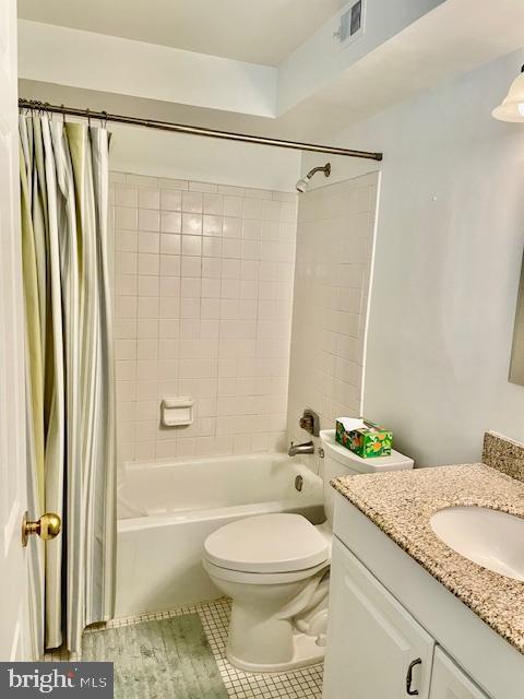 full bathroom with vanity, shower / tub combo with curtain, toilet, tile patterned floors, and visible vents