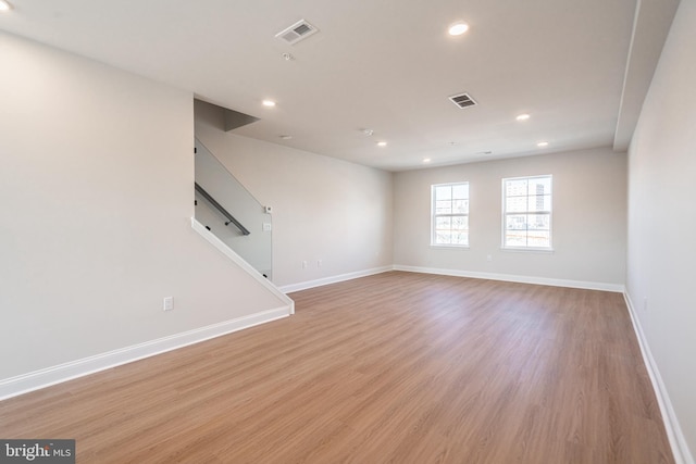 unfurnished living room featuring baseboards, light wood-style flooring, visible vents, and recessed lighting