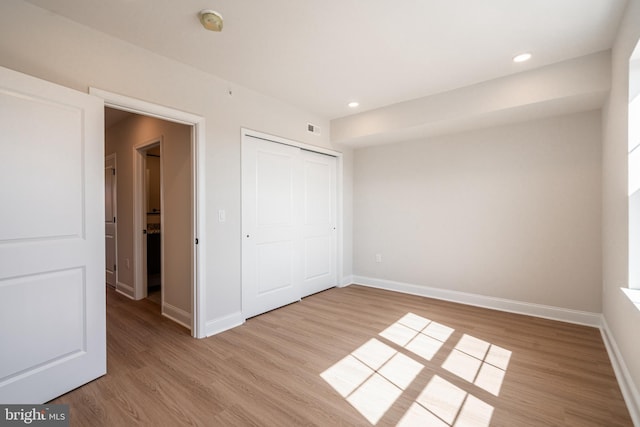 unfurnished bedroom with visible vents, baseboards, recessed lighting, and light wood-style floors