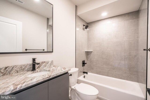 full bath with visible vents, shower / washtub combination, vanity, and toilet