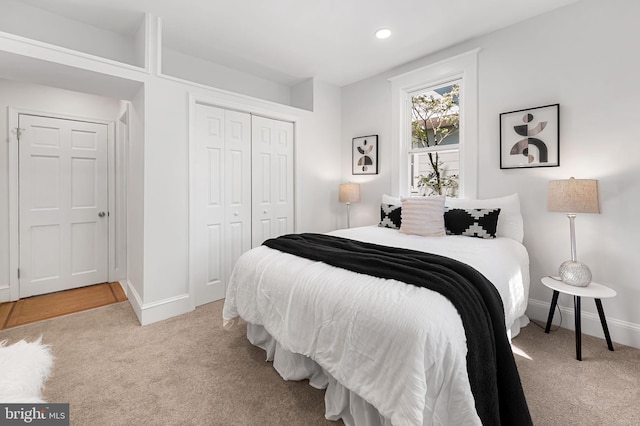 carpeted bedroom with a closet, recessed lighting, and baseboards