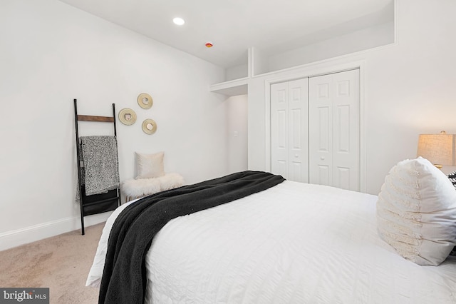 bedroom with a closet, baseboards, and carpet floors