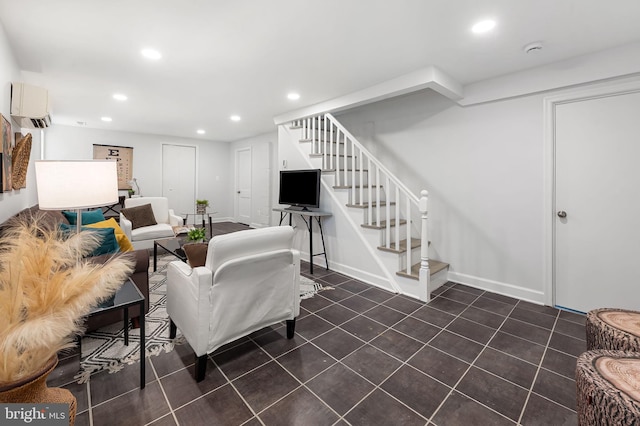 tiled living area with recessed lighting, an AC wall unit, baseboards, and stairs
