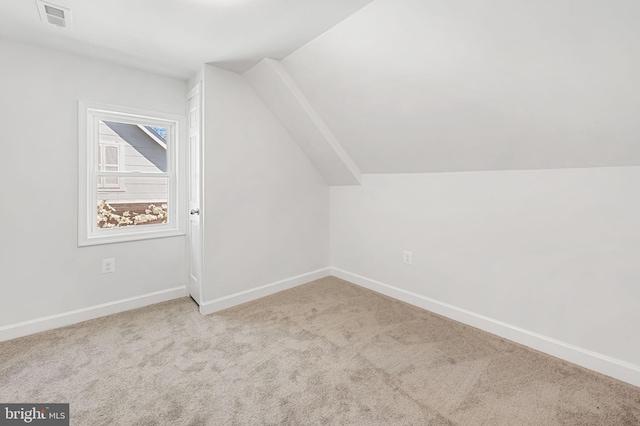 bonus room with carpet flooring, baseboards, lofted ceiling, and visible vents
