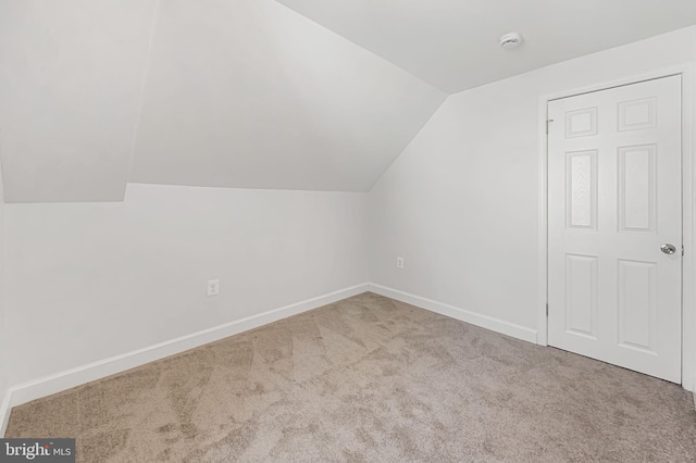 bonus room with baseboards, carpet flooring, and vaulted ceiling