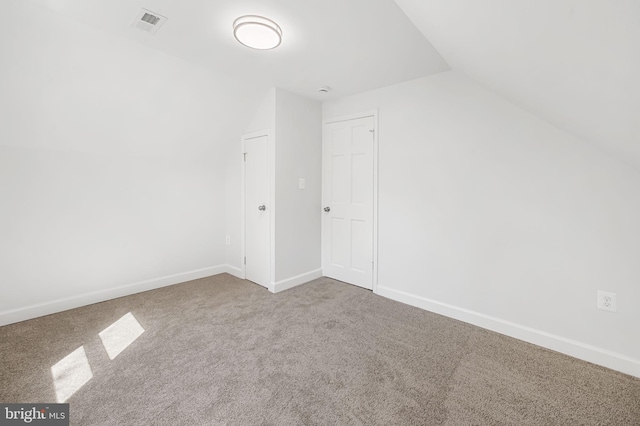 bonus room with carpet flooring, visible vents, lofted ceiling, and baseboards