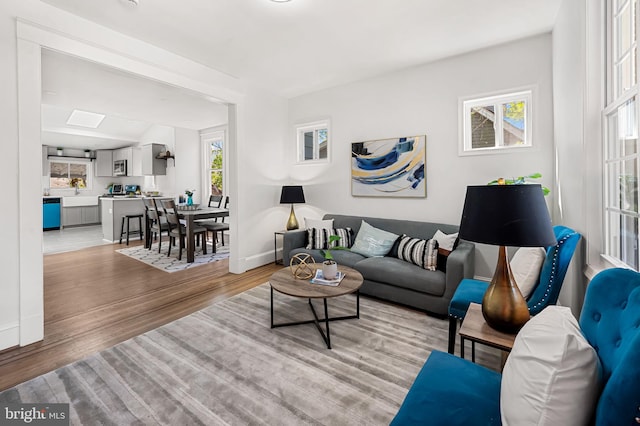 living area with baseboards and light wood-style floors
