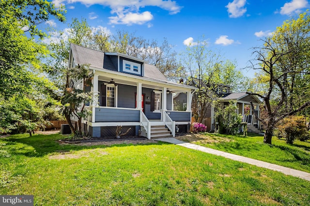 bungalow-style house with covered porch, a ceiling fan, central AC unit, and a front lawn