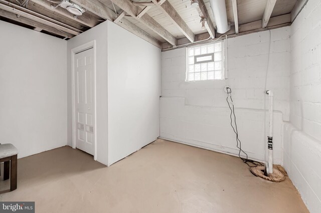 below grade area featuring concrete block wall