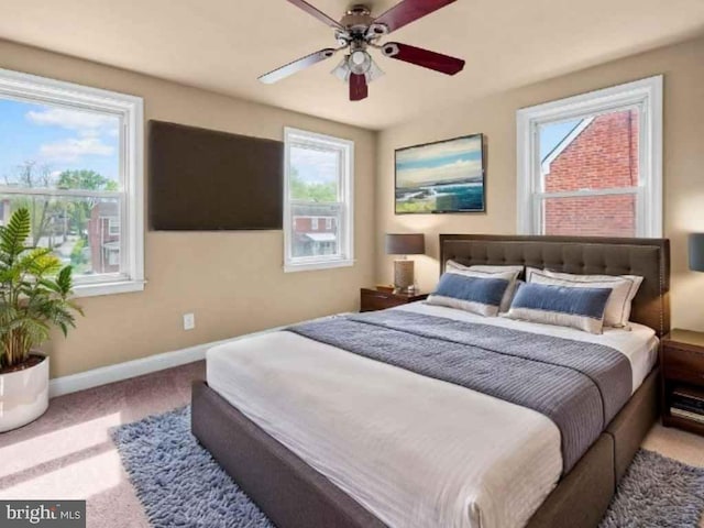 bedroom with carpet, baseboards, and a ceiling fan