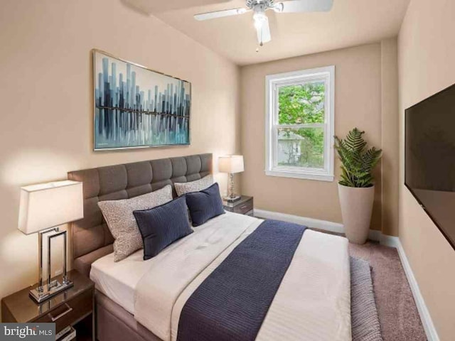 carpeted bedroom featuring baseboards and a ceiling fan