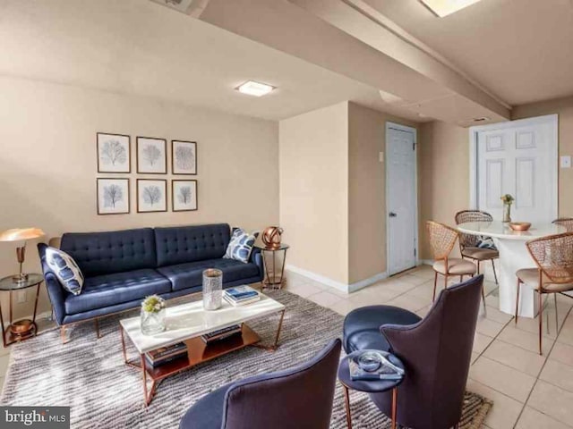 living area featuring baseboards and light tile patterned flooring