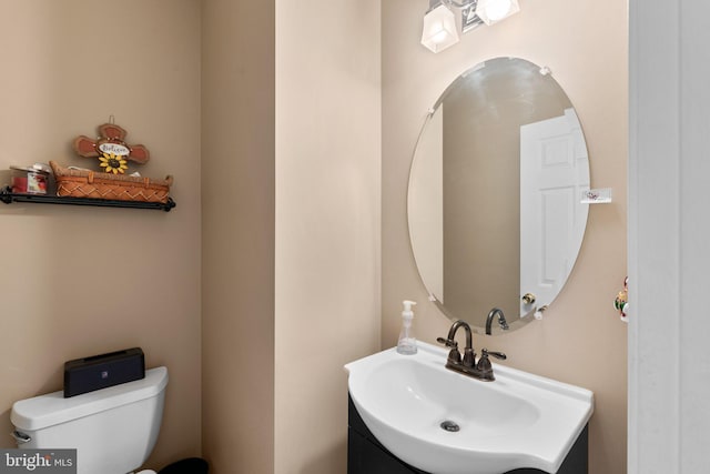 bathroom with toilet and vanity