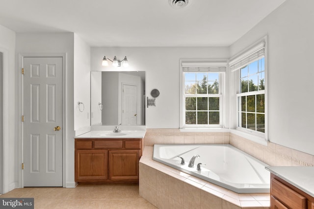 full bathroom featuring a bath, vanity, tile patterned flooring, and visible vents