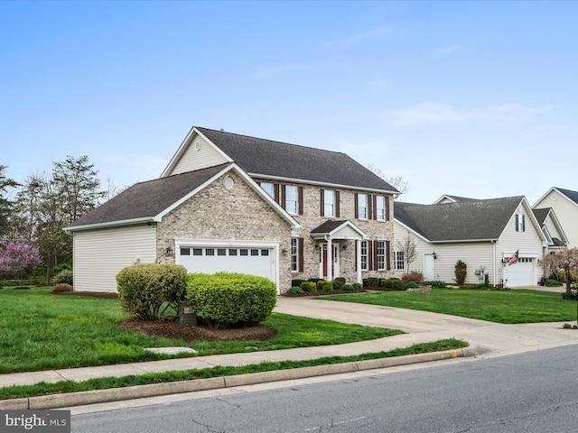 view of front of home featuring concrete driveway, a front yard, and a garage
