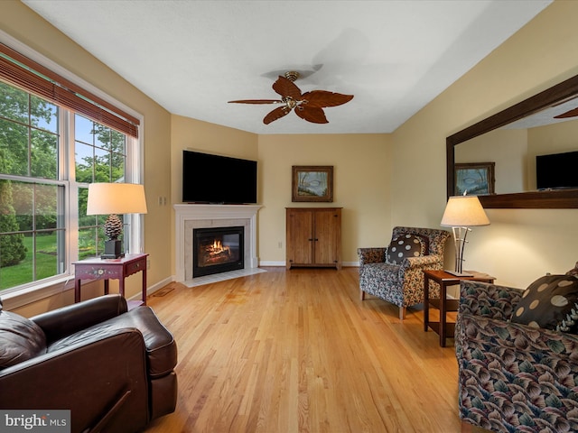 311 Clydesdale Dr, Stephens City, VA 22655 - living area with a ceiling fan, light wood-style flooring, a fireplace with flush hearth, and baseboards