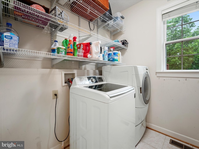 311 Clydesdale Dr, Stephens City, VA 22655 - laundry room with washer and dryer, baseboards, plenty of natural light, and light tile patterned floors