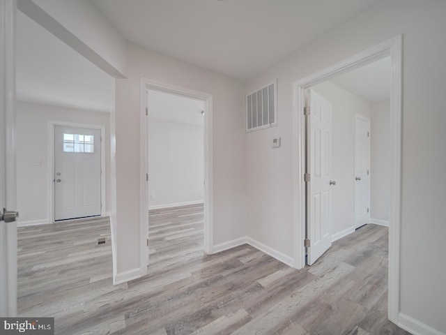 foyer entrance featuring wood finished floors, visible vents, and baseboards
