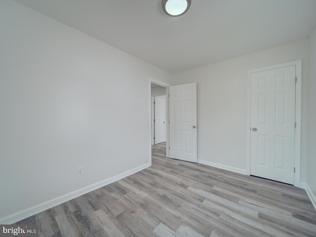 empty room featuring baseboards and wood finished floors