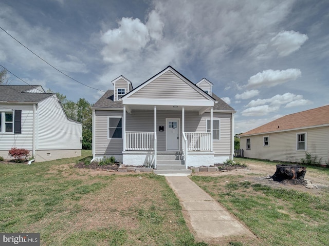 bungalow-style home with a front lawn, roof with shingles, and covered porch