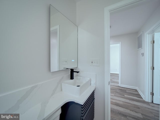 bathroom with vanity, wood finished floors, and visible vents